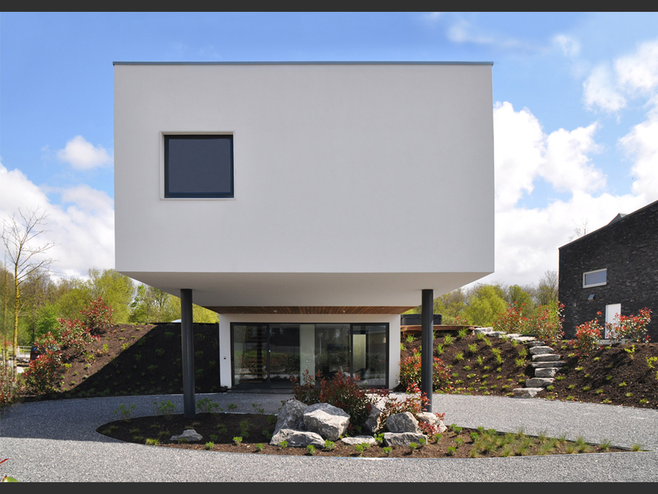 The entrance to the house, a concealed second living-room, a fitness room, and the storage area, are underground The entrance to the house, a concealed second living-room, a fitness room, and the storage area, are underground