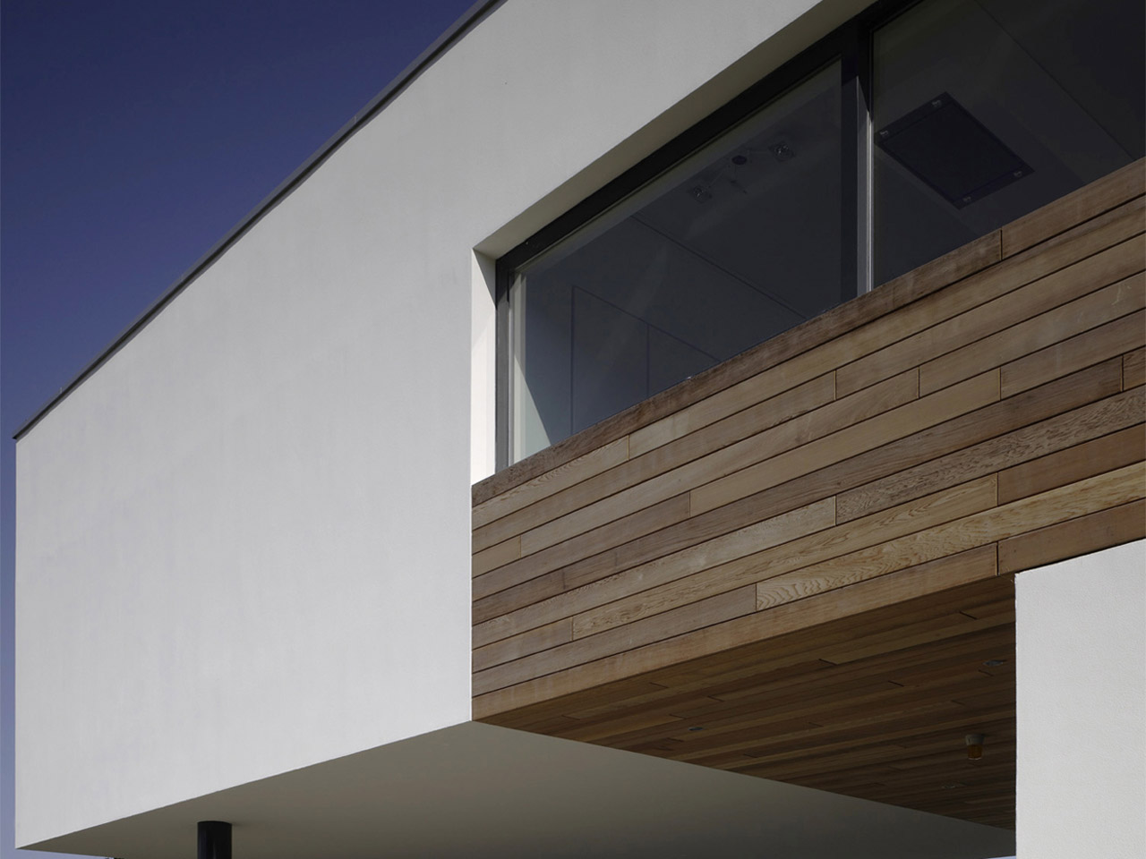 The timbered bottom floor functions as an ample canopy beneath which two cars can be parked The timbered bottom floor functions as an ample canopy beneath which two cars can be parked