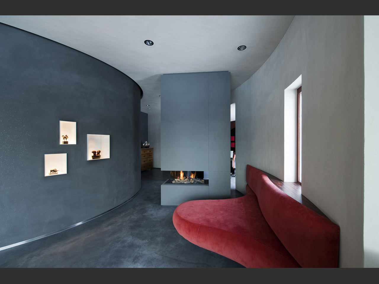 Custom made fireplace and a sofa inspired by the Mae West Lips Sofa by Salvador Dalí.