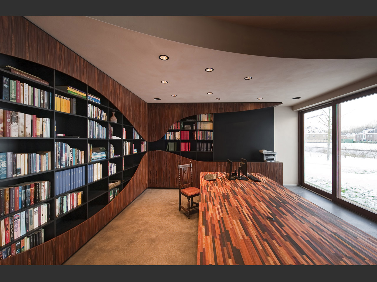 An open workspace with custom made table from mixed wood.